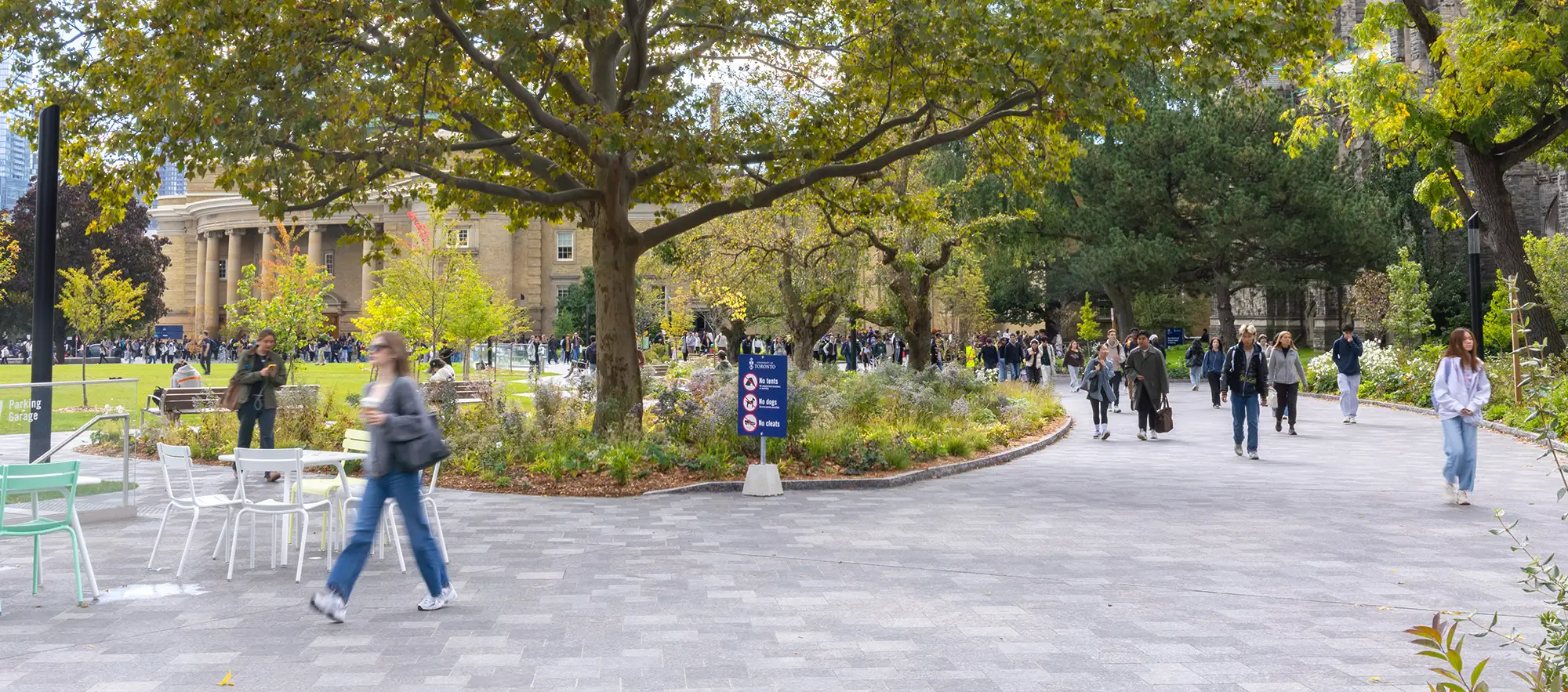 Students and Staff walking in front of Convocation Hall on Front Campus